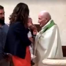 SNIMAK KOJI JE RAZBESNEO MNOGE: Sveštenik na krštenju LUPA ŠAMAR detetu kako bi ga smirio (VIDEO)